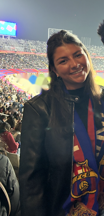 Portrait of Lilly, Director of Club Partnerships for Ekkono Futbol USA, smiling at Camp Nou wearing a full FC Barcelona scarf crest