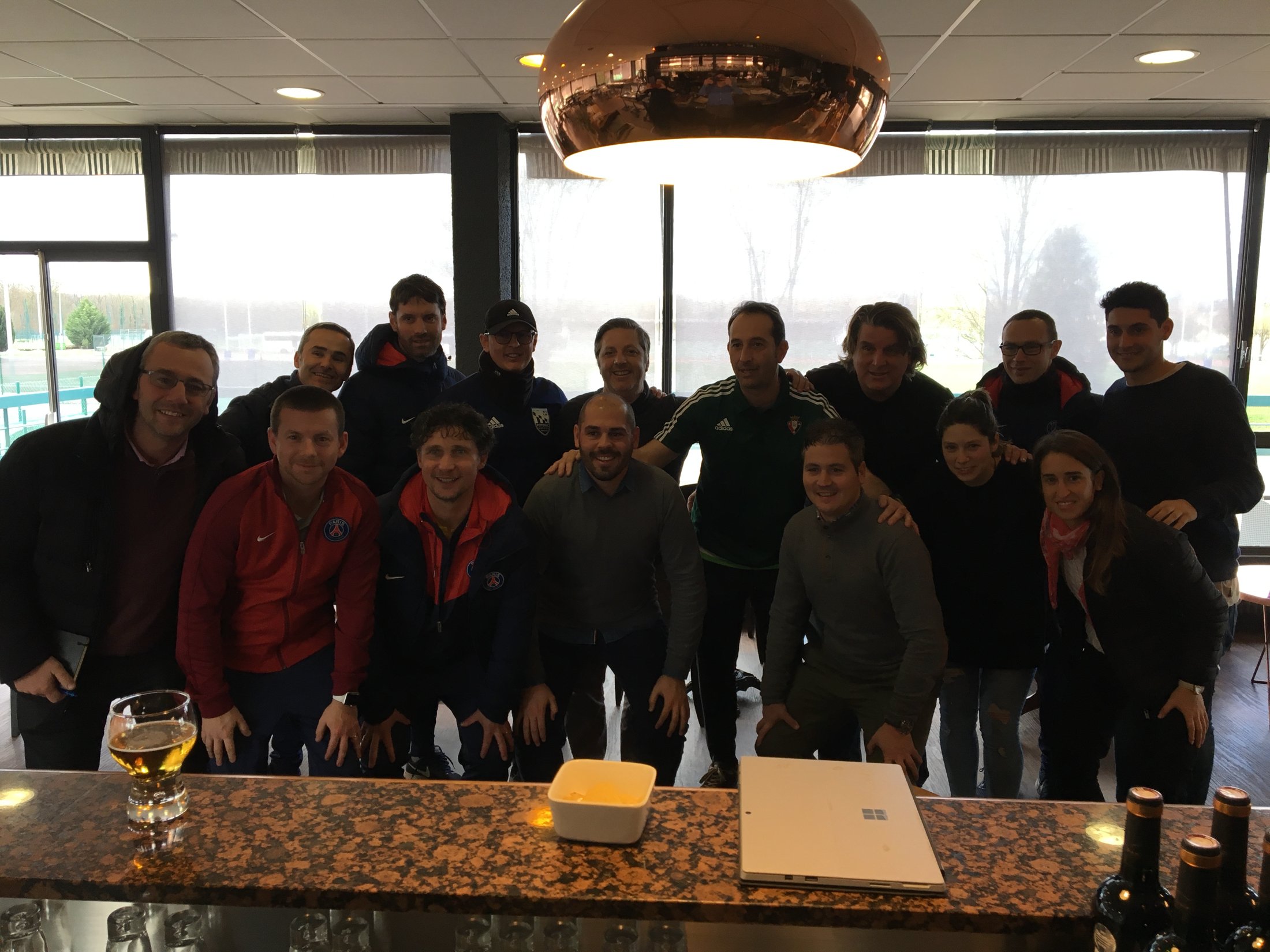 Stefan Triandafilou with Ekkono founders David Hernández and Carles Romagosa and the international coaching cohort at PSG's Camp des Loges